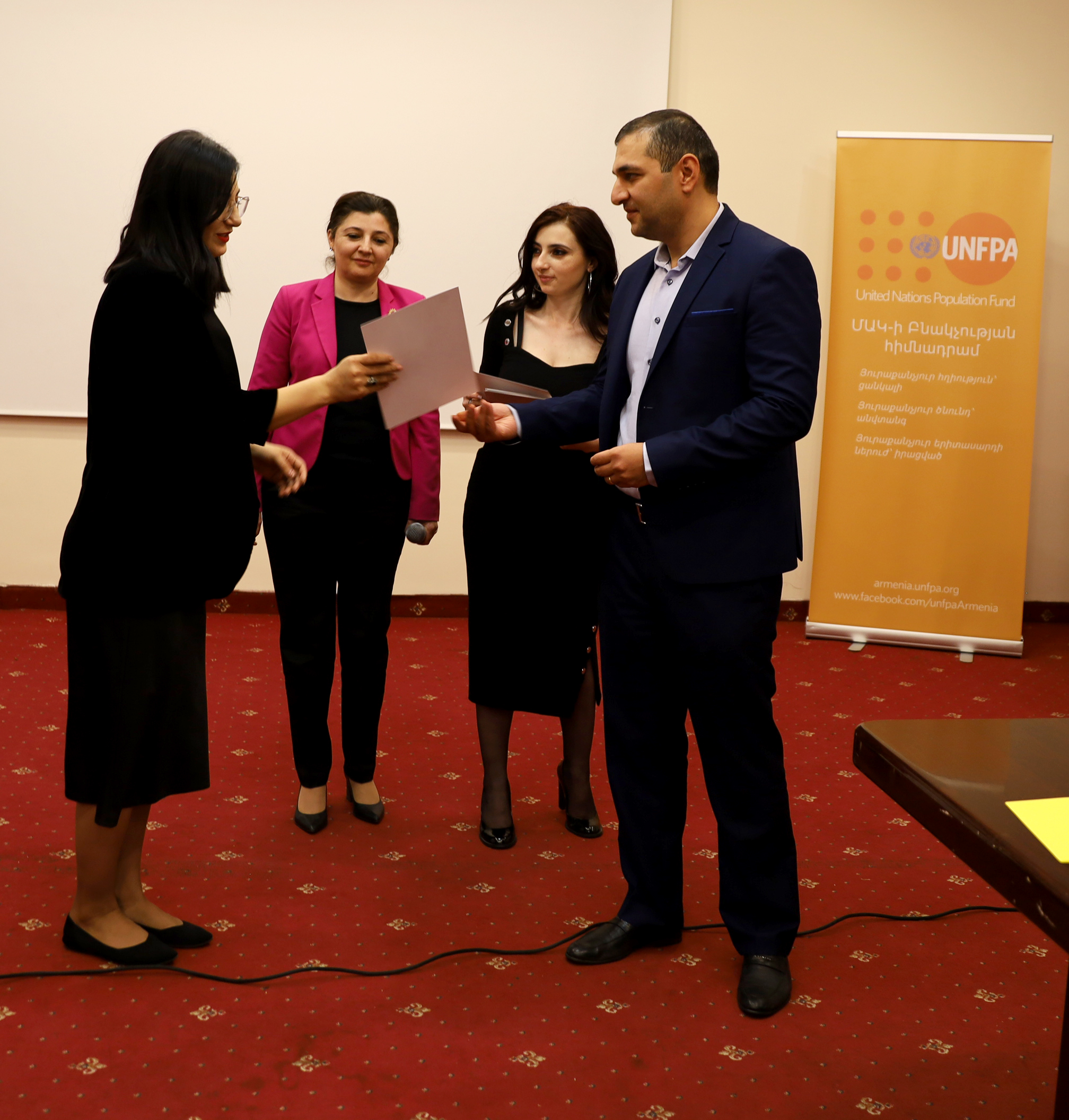 The workshop participants are receiving certificates  from the UNFPA and Ministry of Health 