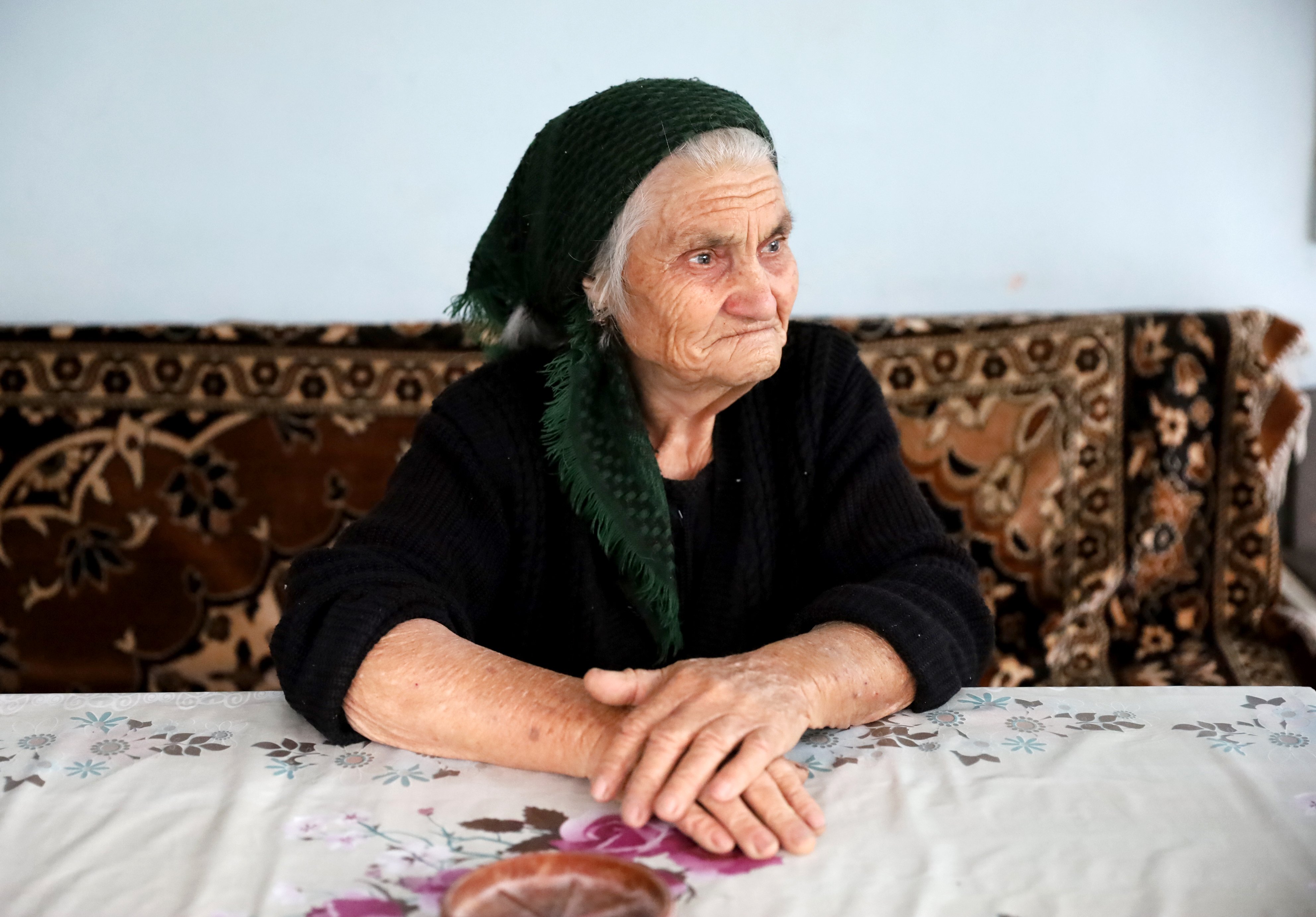 Grandma Goharik sitting in front of the table 