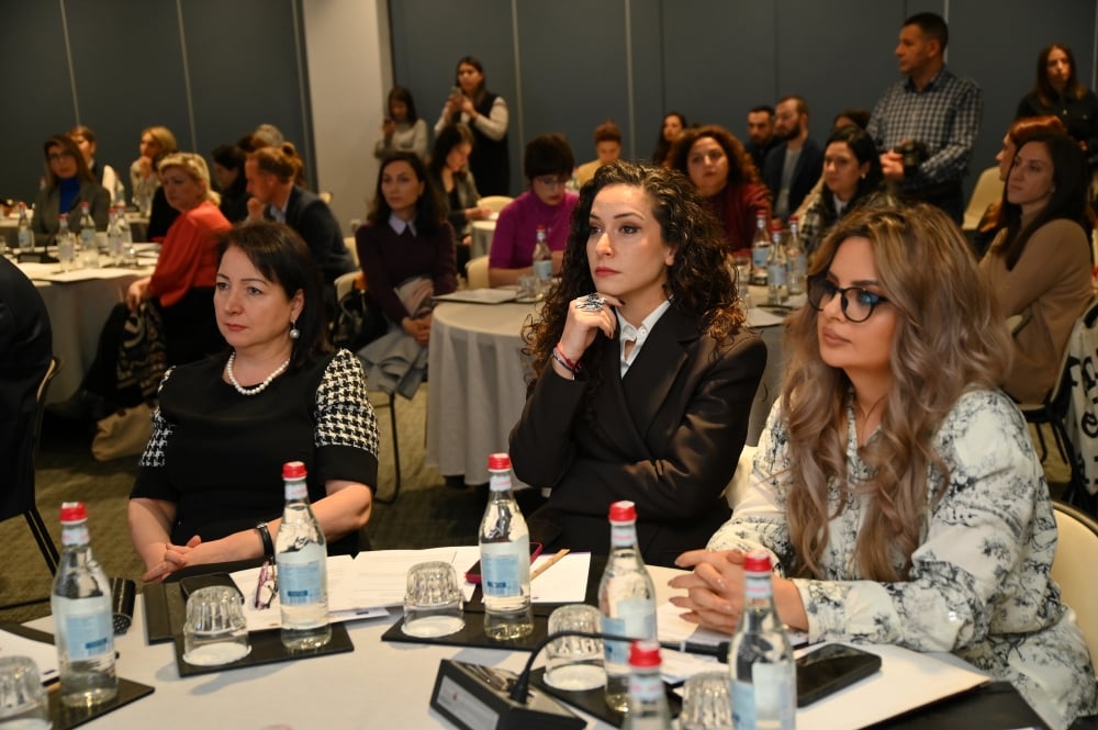 Attendees listening intently at a conference event.