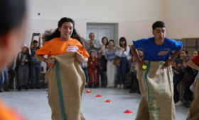 A girl and a boy competing in sack race