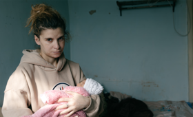 Marta Asriyan, holding her newborn, fifth in the family, whom she gave birth after fleeing to Armenia 