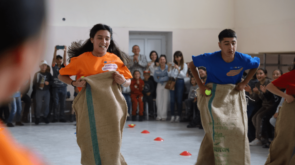 A girl and a boy competing in sack race