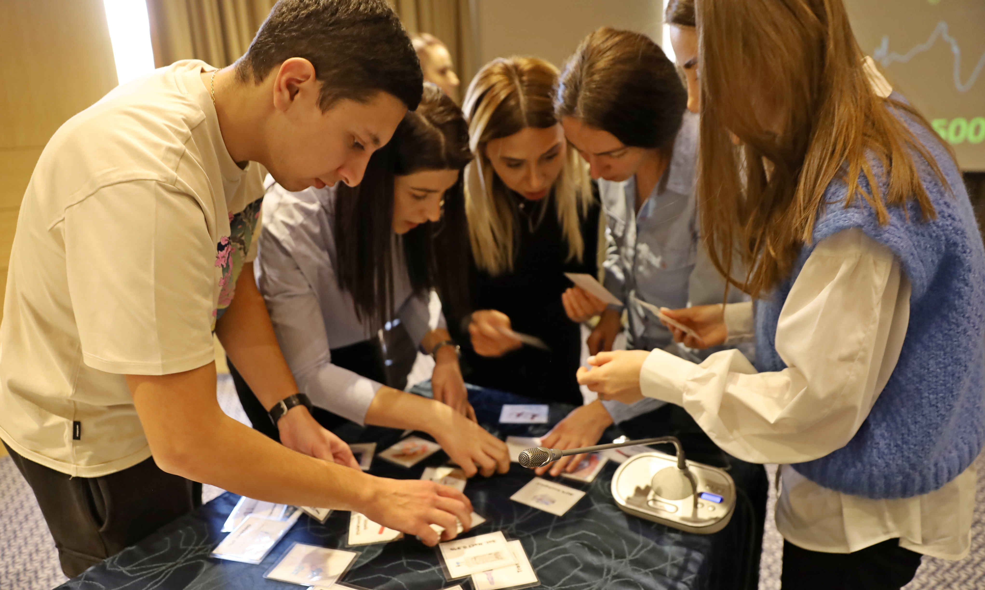 Image of a group of young people actively participating in a workshop on the introduction of clinical guidelines